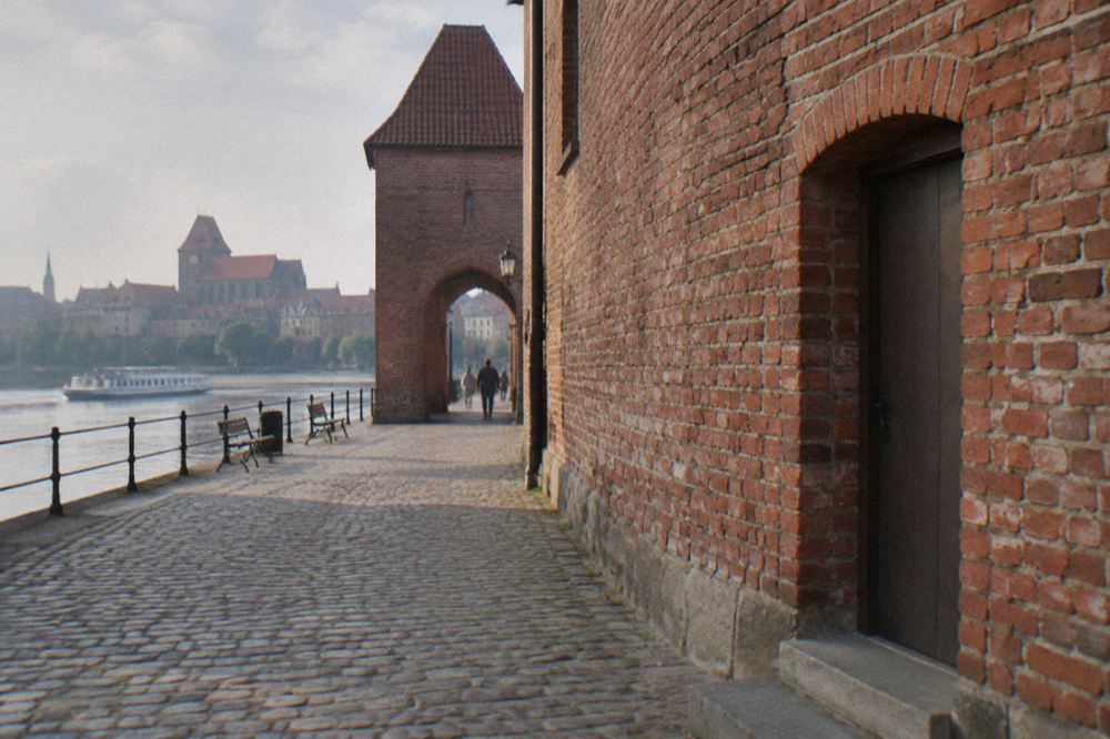 The letters of a street sign on a brick wall in the Old Town of Toruń