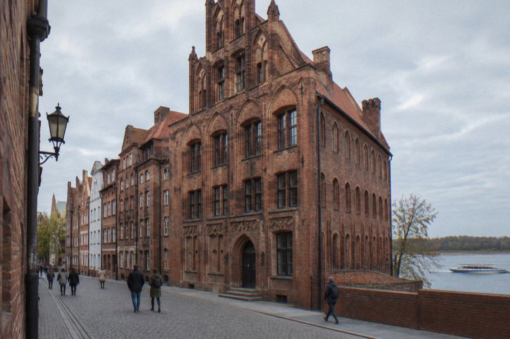Gothic brick townhouses on a narrow street in the Old Town of Toruń