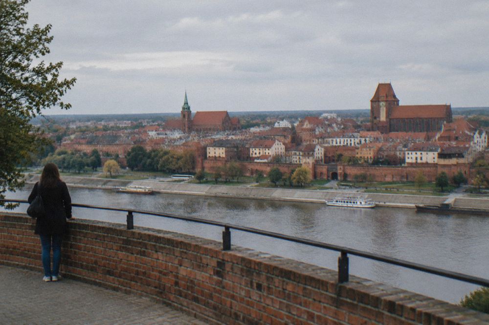 Panorama of red brick roofs and church towers seen from a high viewing terrace