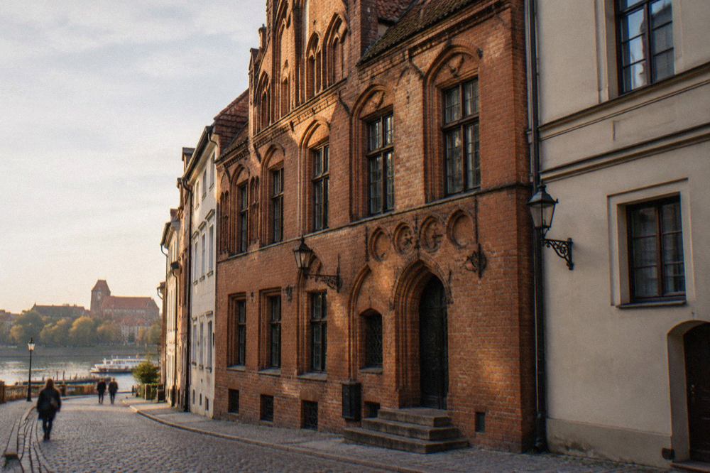 A historic townhouse facade on a narrow Old Town street in Toruń