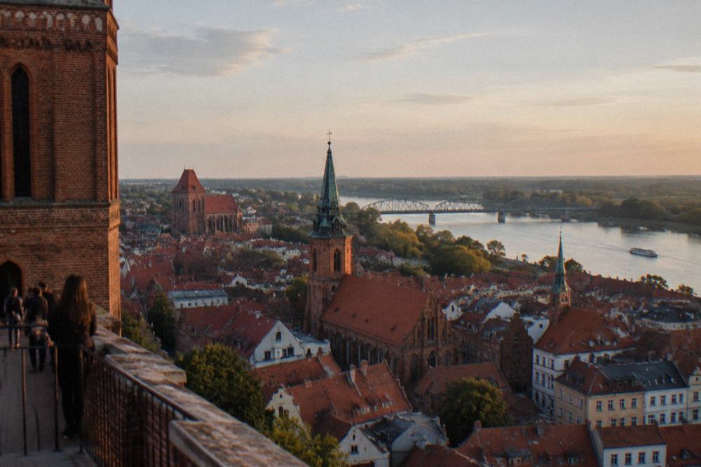 View from a high terrace over red rooftops and church towers of the old town