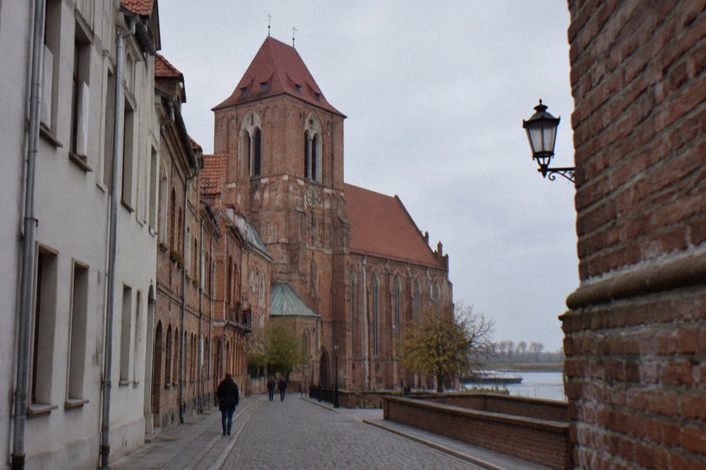 Gothic brick church seen from a narrow Old Town street