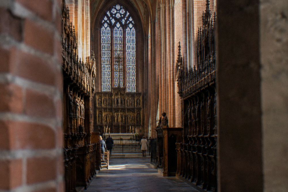 Carved wooden choir stalls running along both sides of a Gothic chancel