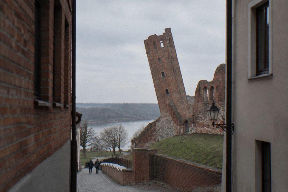 The leaning medieval tower seen from the street in Toruń