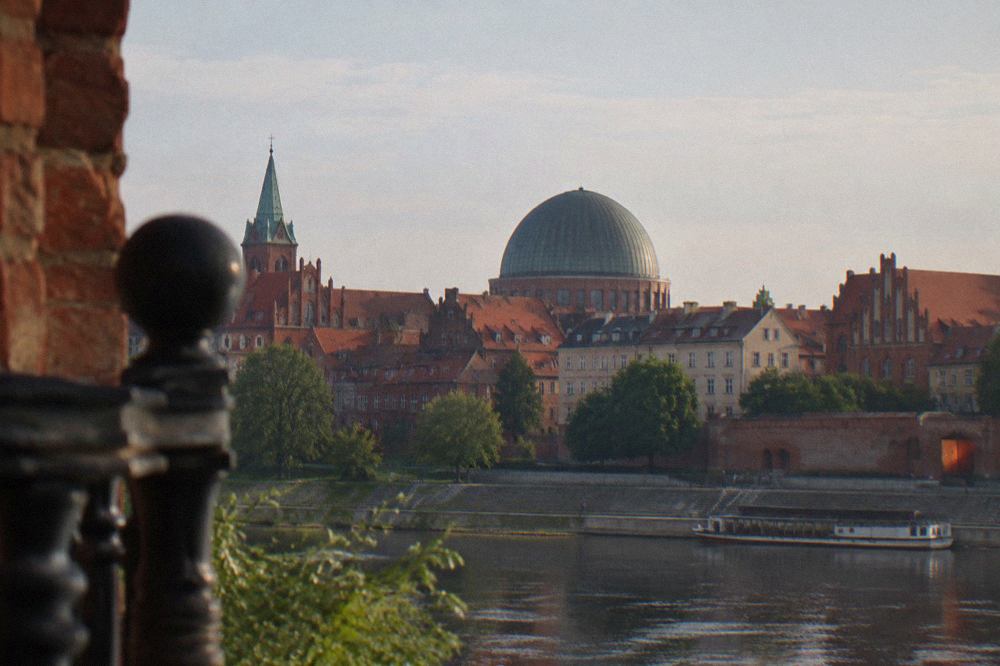 The planetarium dome rising behind Old Town rooftops in Toruń
