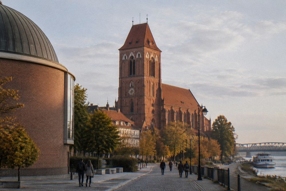 The tower of St Mary's Church seen from the street outside the planetarium in Toruń