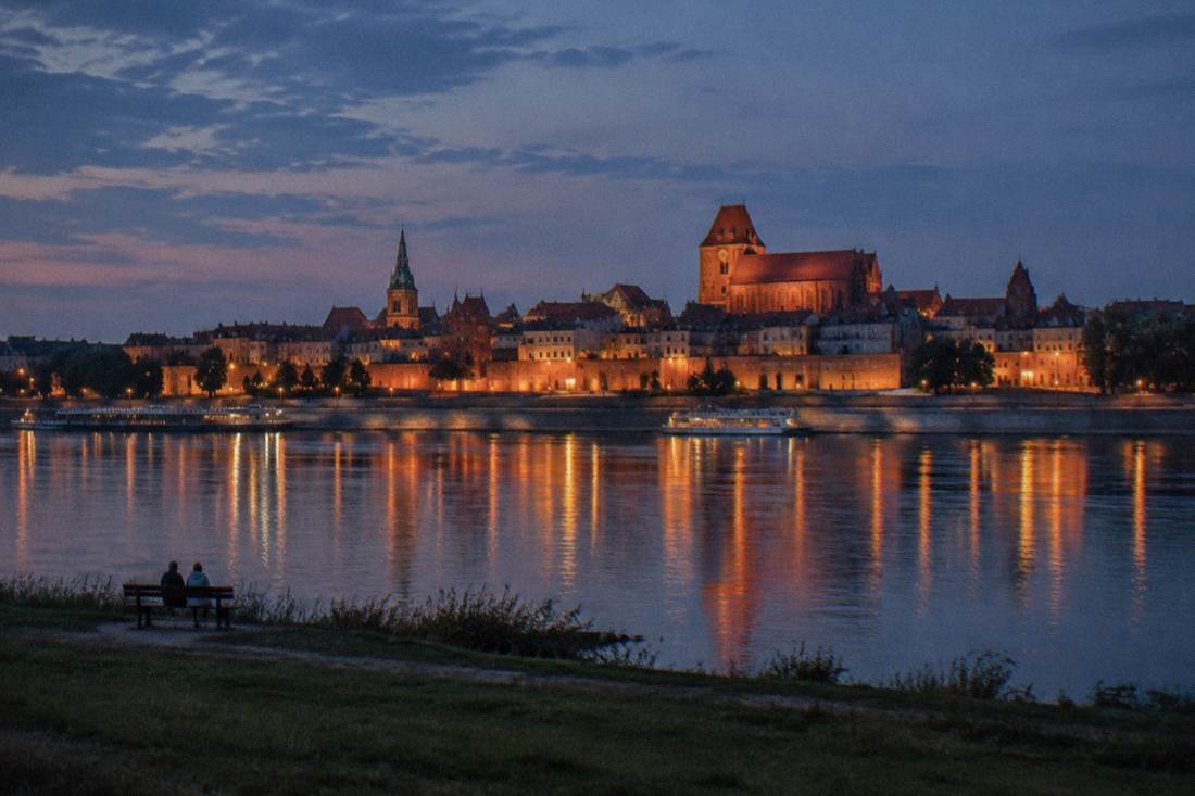 The Toruń Old Town skyline reflected in the Vistula at blue hour