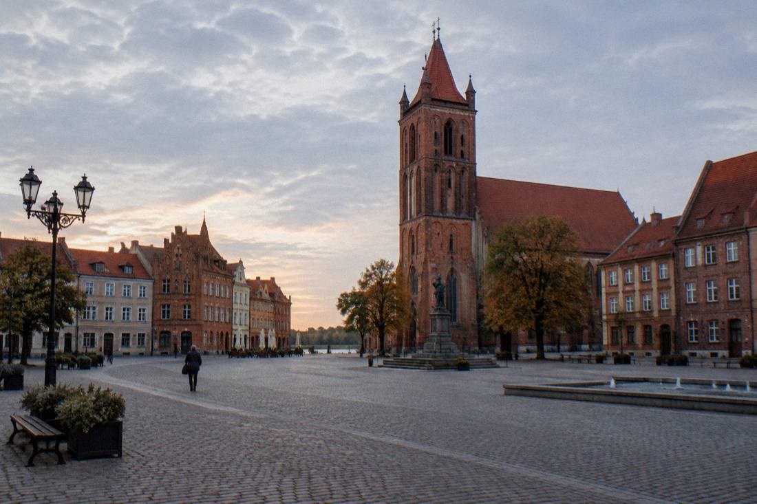 The New Town market square in Toruń with a church tower and low brick houses