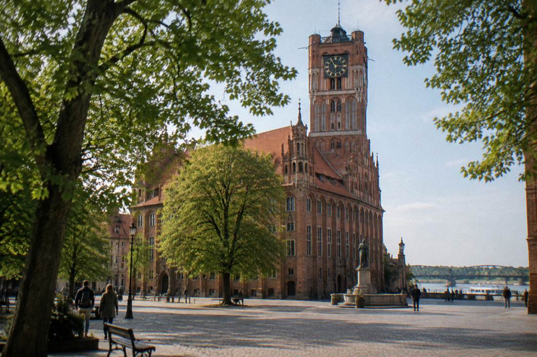 The brick Old Town Hall of Toruń with its tall tower above the square