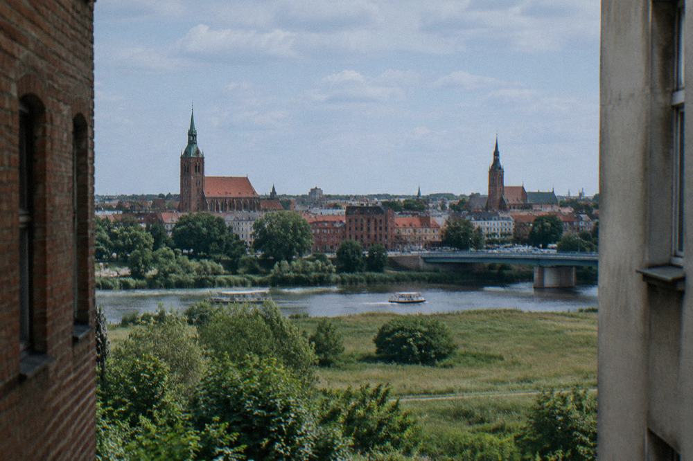 A town skyline with church towers seen across open countryside