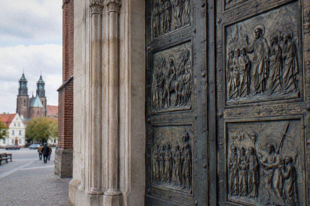 Ornate bronze relief panels on a set of medieval church doors