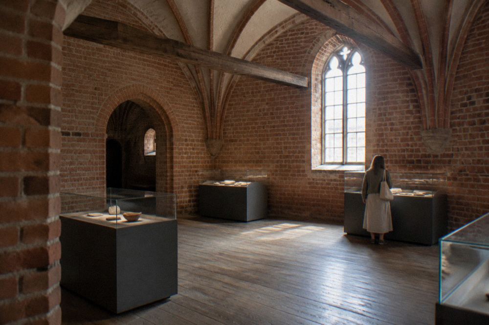A museum interior inside a brick granary with wooden beams and display cases