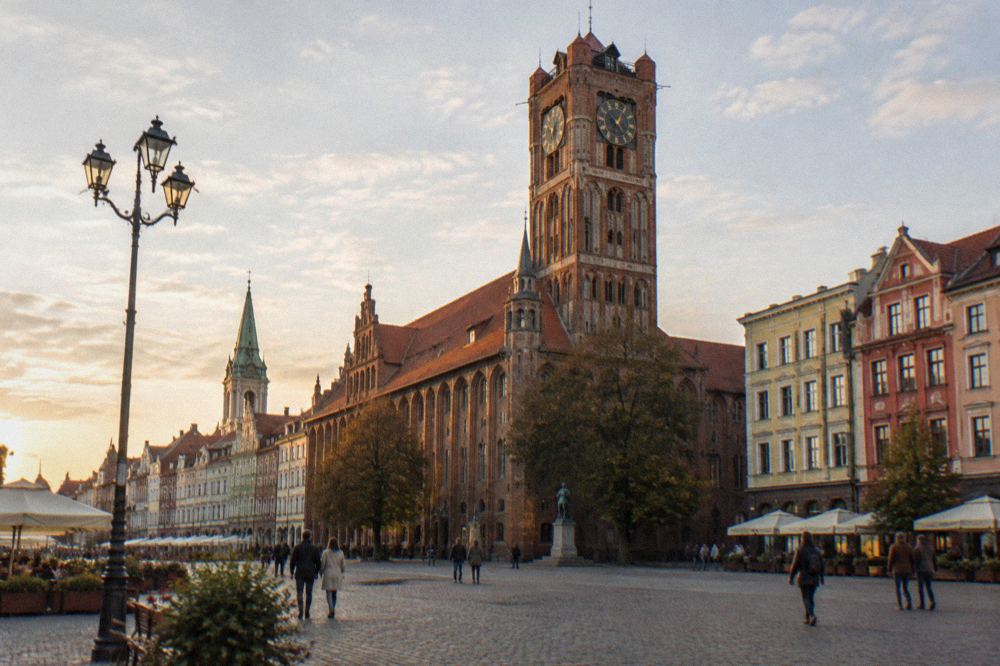 Market square with a gothic town hall tower and colourful townhouses
