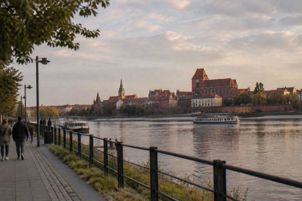 Riverside promenade along the Vistula with gothic city panorama of Toruń