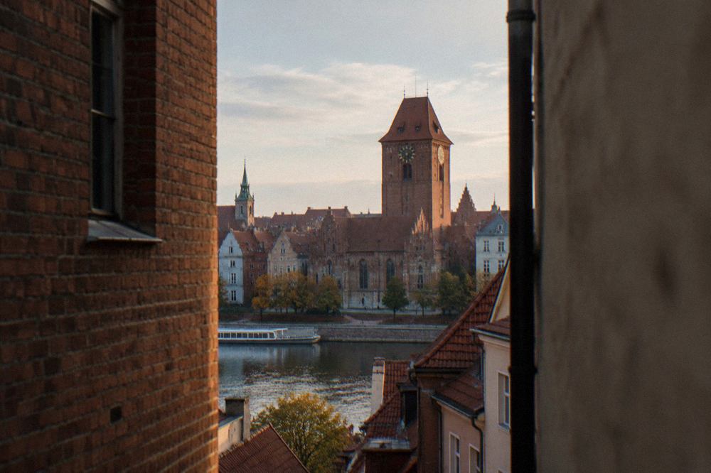The red-brick Old Town Hall tower rising above the rooftops of Toruń Old Town