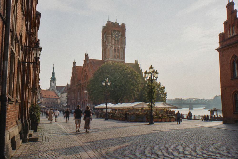 Cobbled street lined with Gothic brick facades in Toruń's Old Town