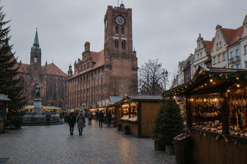 Wooden market stalls with lights standing on a medieval square in Toruń