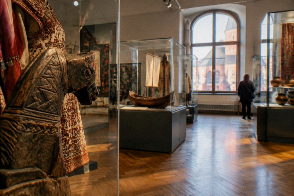 Museum gallery with ethnographic displays and artefacts in glass cases