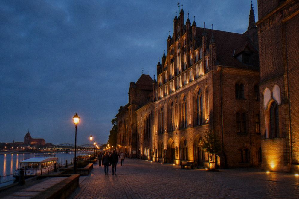 Evening lights on the illuminated facade of a Gothic museum building in Toruń