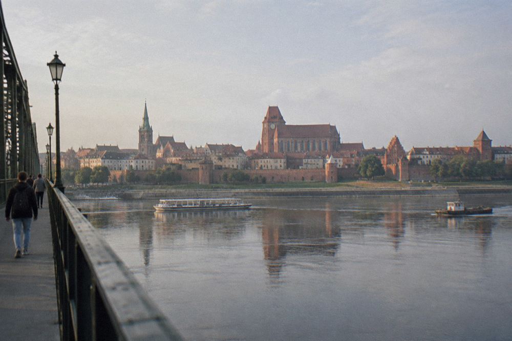 View across the Vistula river to the skyline of Toruń Old Town with church towers and walls