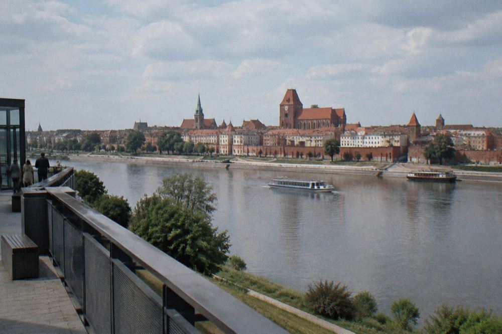 The Panorama Torunia viewing terrace on the left bank facing the Torun Old Town skyline across the Vistula