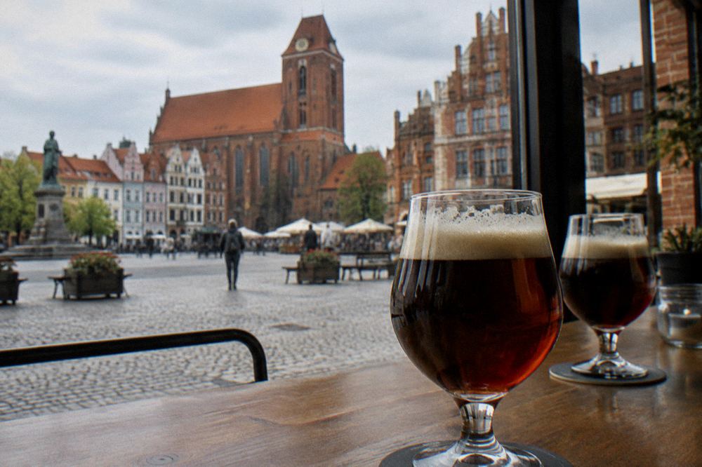 Glasses of dark gingerbread beer on the bar of a brewery restaurant