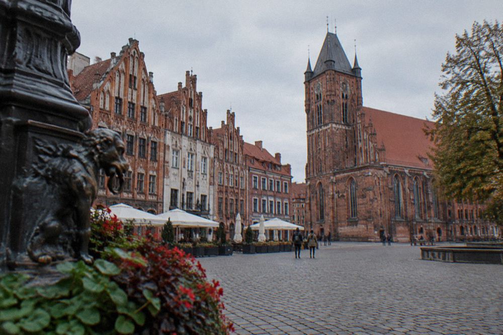 Cobbled square in Toruń Old Town lined with Gothic townhouses