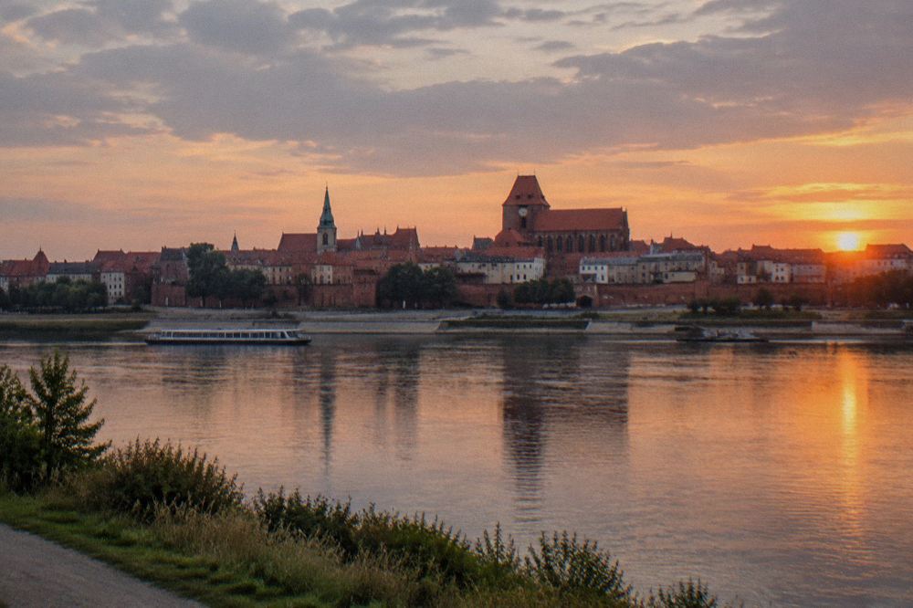 The Vistula river and Toruń Old Town panorama seen from the opposite bank at sunset