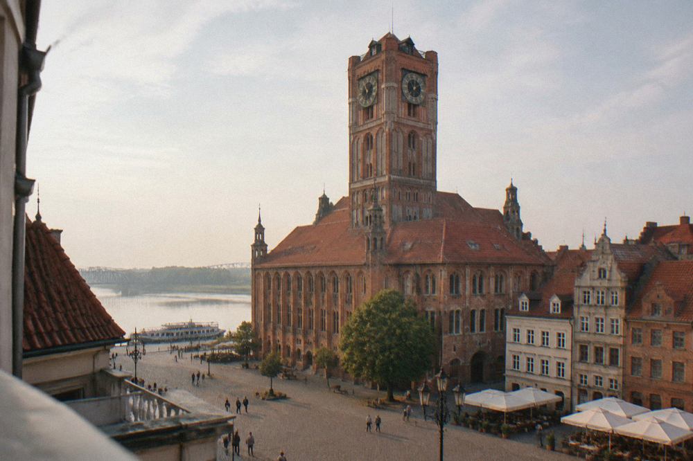 The Gothic Old Town Hall of Torun rising above the red rooftops of the market square